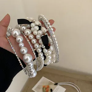 Selection of French retro white pearl and rhinestone headbands with bow details