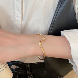 Elegant minimalist irregular wavy gold open cuff bracelet for modern women's jewelry collection