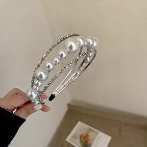 Close-up of elegant double-layered headband with white pearls and sparkling rhinestones