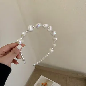Detailed view of white pearlescent heart-shaped bead headband for hair accessories