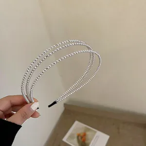 Macro view showing the intricate triple-layer design of this vintage white pearl headband.