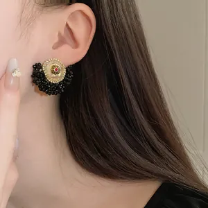 Close-up macro view of vintage French style crystal flower stud earring worn by a model
