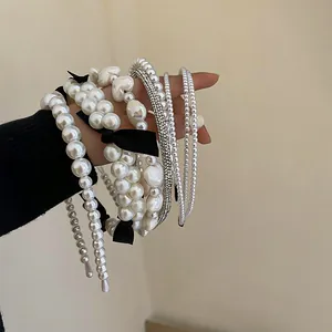 Detail of elegant French vintage pearl and rhinestone headbands with black bows.