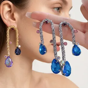 Vintage style woven silver needle earrings featuring blue and purple teardrop crystals