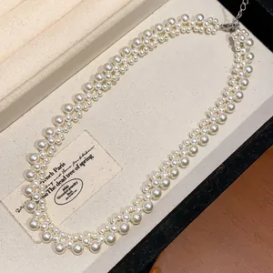 Elegant French vintage style double-strand pearl necklace displayed in a jewelry box.