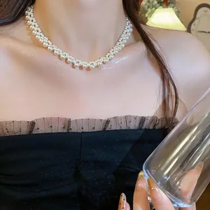 Close-up of elegant multi-layer pearl necklace worn by female model for retro look