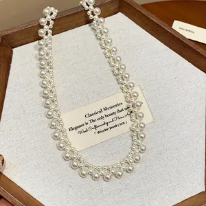 Close-up of French vintage multi-layered pearl necklace in wooden jewelry box