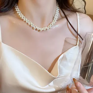 Close-up detail of an elegant French retro multi-layer pearl choker necklace on a woman
