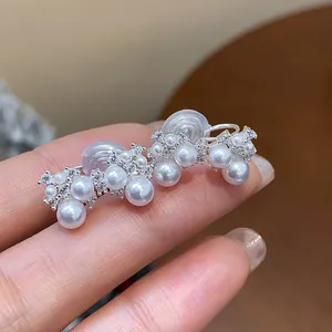 Elegant French-style zircon and pearl clip-on earrings shown in a detailed close-up view
