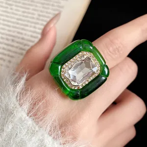 Detailed view of vintage green resin statement ring with a large faceted crystal stone