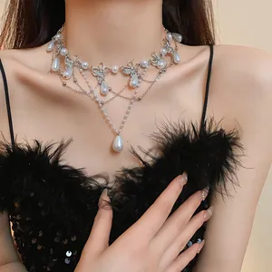 Detailed view of a butterfly pearl necklace with rhinestone accents on a model.