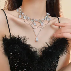 Close-up detail of a French vintage butterfly necklace with pearls and rhinestones on model