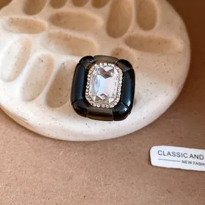 Close-up of a vintage resin hexagonal ring with pleated texture and central crystal