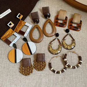 Collection of vintage bohemian earrings featuring wood resin and gold foil details