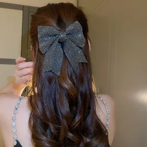 Elegant sparkling black rhinestone bow hair clip for women with sophisticated hairstyles