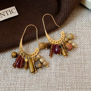 Detailed view of vintage ethnic gold-plated earrings featuring multi-color stone tassels.