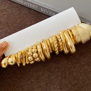 Detailed macro view of the textured gold earring set featuring irregular wrinkled designs.