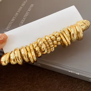 Close-up detail of gold irregular wrinkled hoop earrings set displayed on a jewelry card