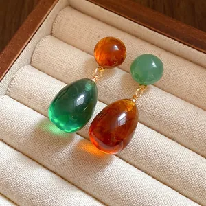 Elegant vintage asymmetric resin teardrop earrings in amber and emerald green colors