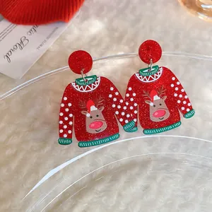 Detailed view of red Christmas sweater earrings with reindeer and glitter finish.