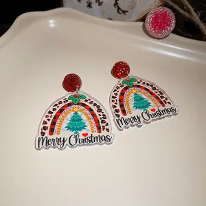 Detail view of festive acrylic Christmas earrings featuring rainbow and Merry Christmas text