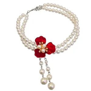 Elegant double-strand pearl necklace with red flower pendant and pearl tassels