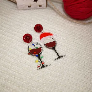 Detailed view of creative acrylic Christmas wine glass earrings with Santa hat design