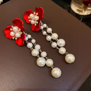 Detail of vintage court style flower earrings with rhinestones and cascading pearls