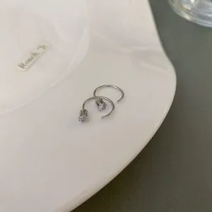 High-quality close-up of silver spiral ear hooks featuring micro-pave CZ stones