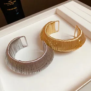 Elegant metal wire woven open cuff bracelets for women in gold and silver finish.