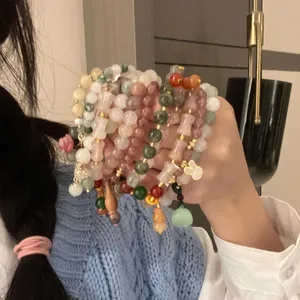 Elegant New Chinese style gourd and jade elastic beaded bracelets held in hand for display