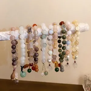 Set of New Chinese style gourd jade beaded stretch bracelets displayed on a branch