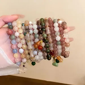 Close-up of a hand displaying multiple New Chinese style gourd jade beaded elastic bracelets
