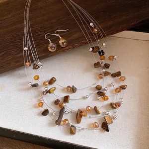 Vintage multi-layer Tiger's Eye beaded necklace and earring set on beige display