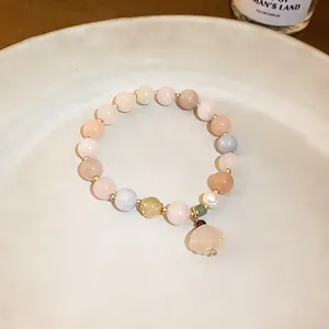 Detailed macro view of a New Chinese style jade beaded bracelet with a flower pendant