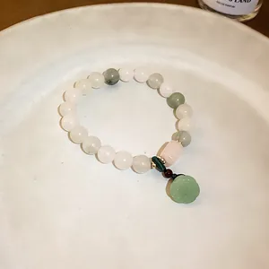 Close-up detail of new Chinese style jade beaded bracelet with elegant green pendant