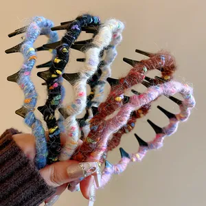 Macro detail of various colorful wool yarn-wrapped wavy headbands with comb teeth.