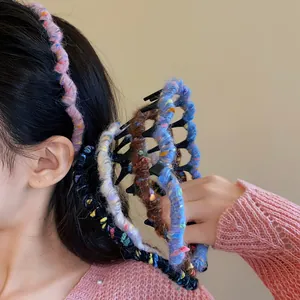 Close-up detail view of colorful yarn-wrapped wavy headbands in various autumn colors