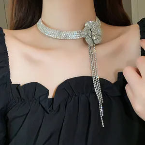 Elegant rhinestone flower choker necklace with sparkling long tassels detail on a female model