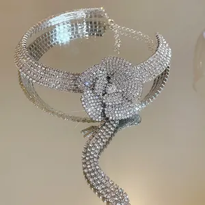 Macro view of silver rhinestone flower choker necklace featuring elegant sparkling crystal tassels