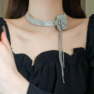 Detail shot of shimmering rhinestone flower choker with elegant long tassels