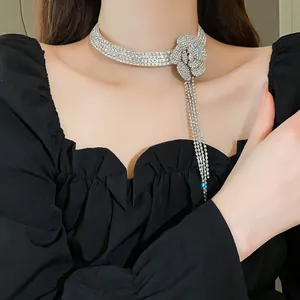 Close-up of elegant rhinestone camellia flower choker necklace with dangling tassels