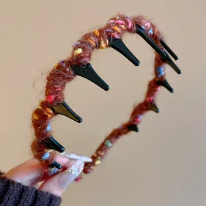 Close-up of colorful wool wrapped headband with teeth for autumn winter hair styling