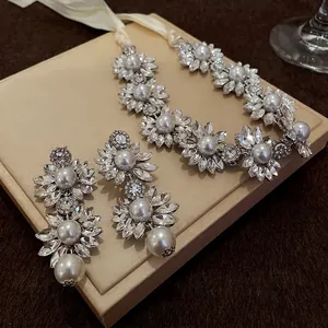 Vintage floral rhinestone and pearl necklace and earring set with white ribbon