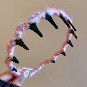 Close-up macro detail of soft pink knit wool-wrapped wavy headband showing yarn texture