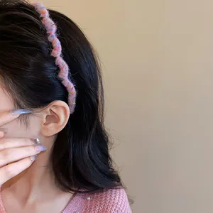 Close-up of a pink wool-wrapped wavy headband on a model, showcasing sweet winter style