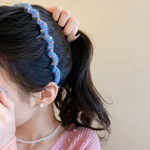 Detail view of a blue wool-wrapped wavy headband showing soft texture and cozy winter style