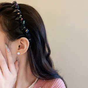 Detailed close-up showing a colorful wool-wrapped wavy headband on a stylish hair model