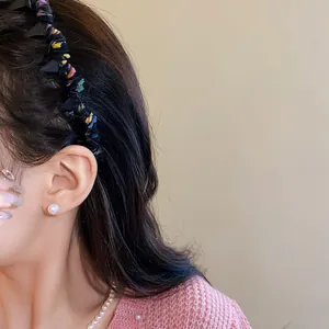 Close-up of a colorful wool-wrapped wavy headband worn by a model for a stylish look