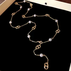 Detailed view of an elegant gold-plated pig nose pearl necklace on black velvet